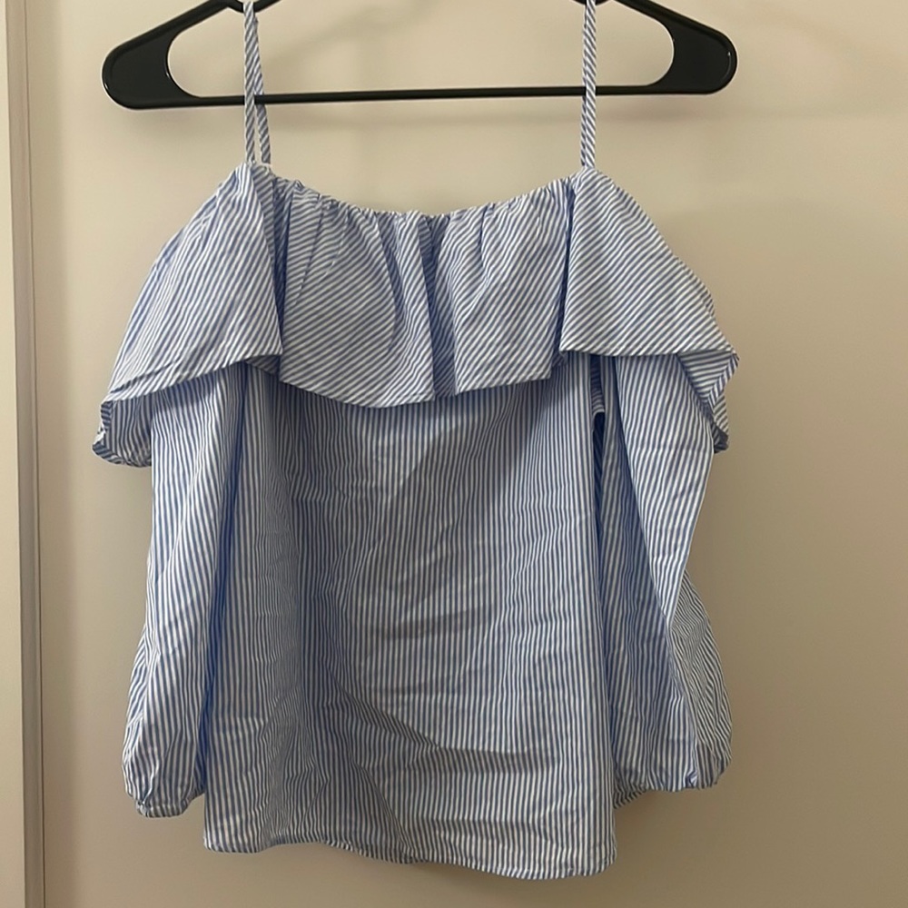 Women’s summer top. Blue and white with mid sleeves and a cute front line.
